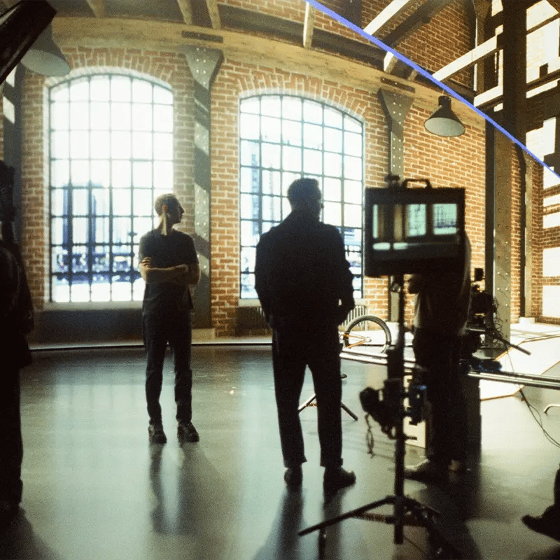 A film crew setting up a shot in front of an LED wall running Unreal Engine to power a virtual environment