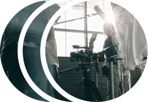 A film crew preparing for a shot with a RED cinema camera on a tripod