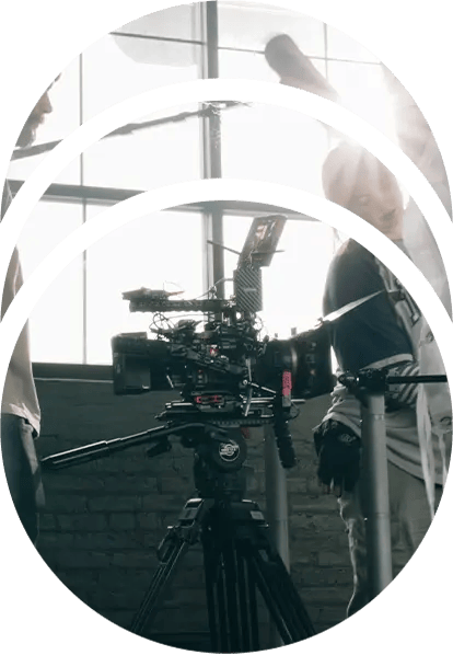 A film crew preparing for a shot with a RED cinema camera on a tripod