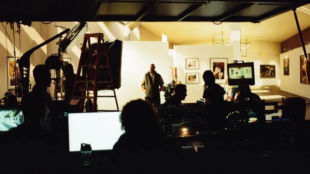 A view from the tech booth of a virtual production stage where a virtual production supervisor operates the LED wall from