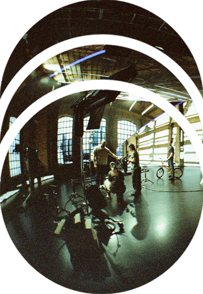 A stylized image of a film crew standing on set and operating a Dana Dolly