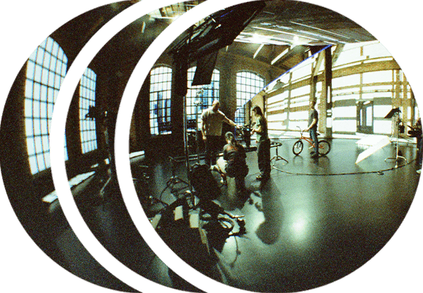 A stylized image of a film crew standing on set and operating a Dana Dolly