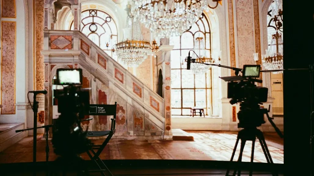 Two red cinema cameras in front of an LED wall in a virtual production studio