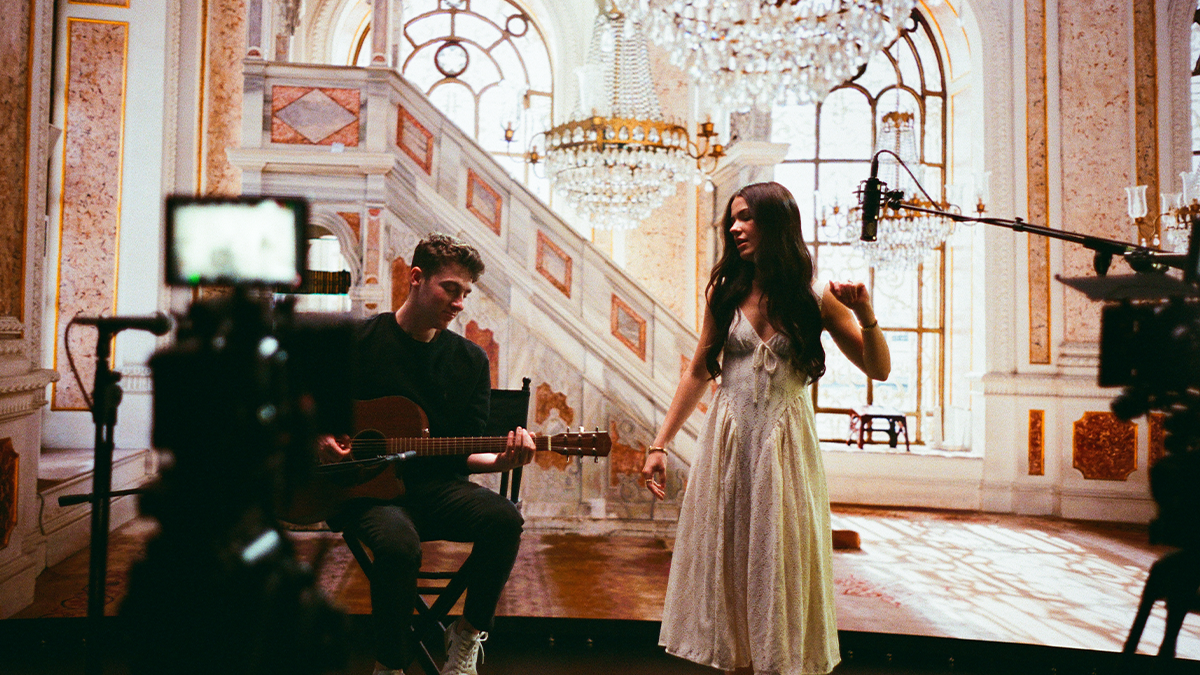 A musician is filmed against an LED wall for virtual production.