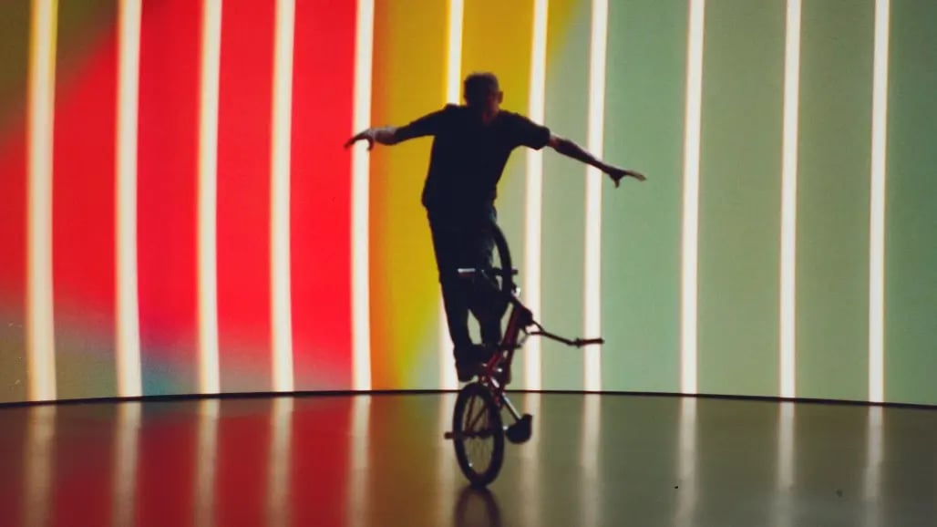 A BMX biker does a trick in front of a virtual production stage LED wall