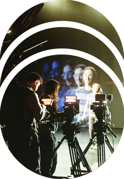 A director standing in front of an LED wall while camera operators use RED cinema cameras