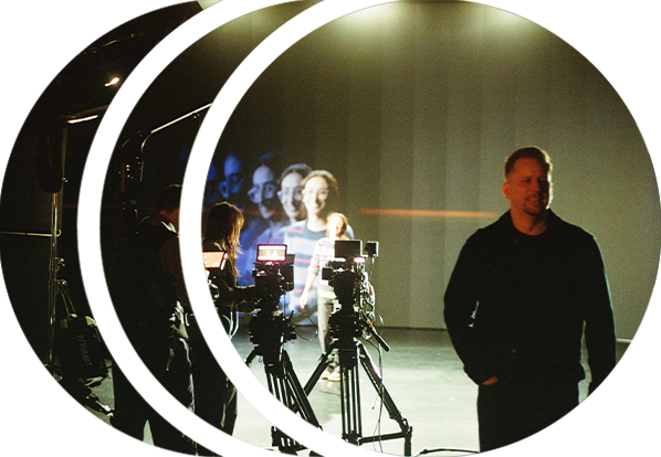A director standing in front of an LED wall while camera operators use RED cinema cameras