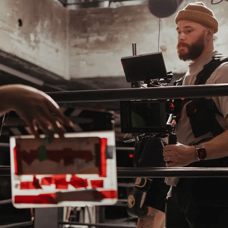 A second AC slates for the cinematographer at the start of a take in a boxing ring