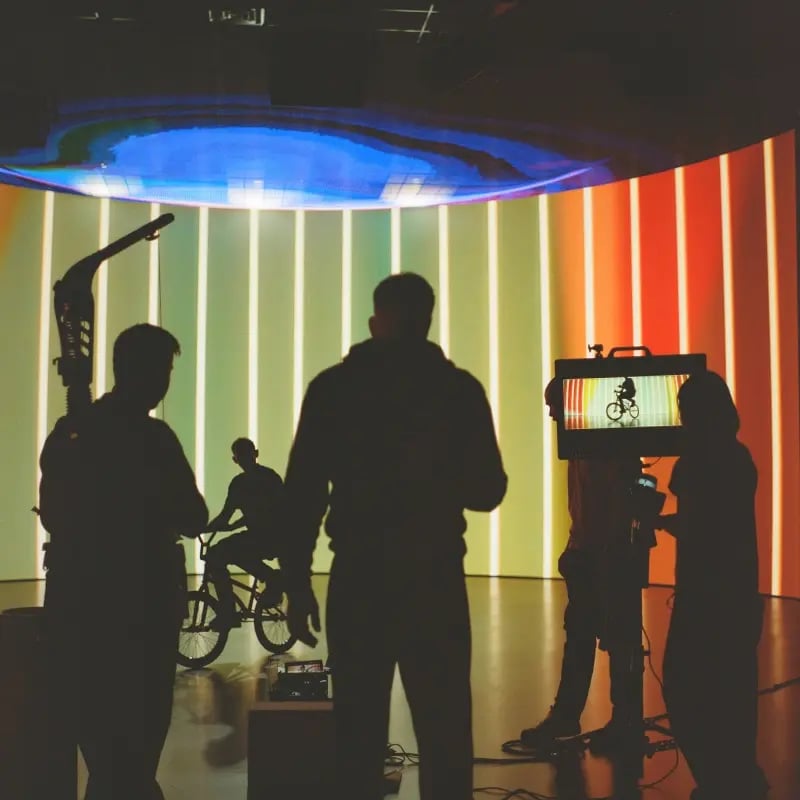 A film crew stands in front of a virtual production LED wall