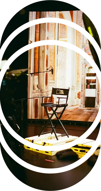 A directors chair sits on apple boxes in front of an LED wall