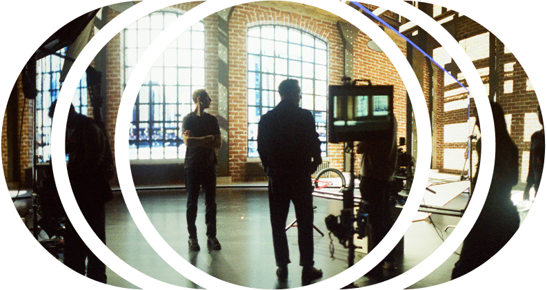 A film crew is working on setting up a shot in front of an LED wall running Unreal Engine
